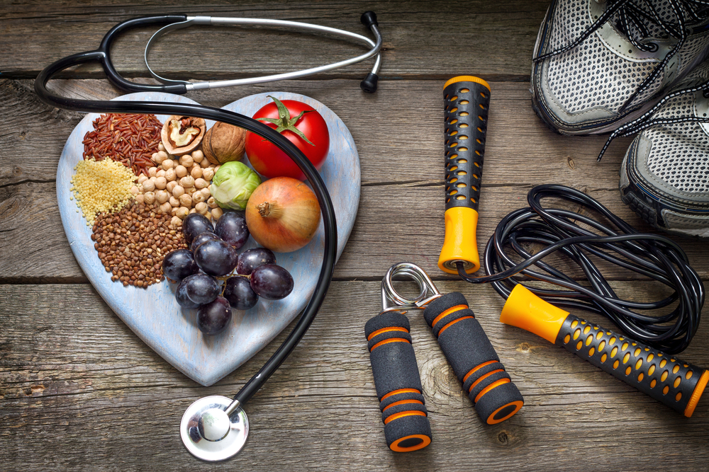 whole foods on heart shaped plate with fitness tools